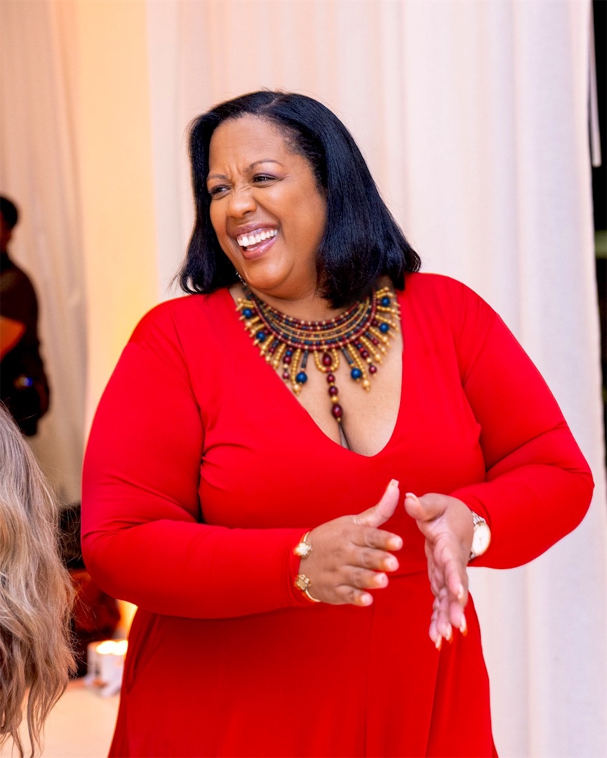 Queen B laughing in red