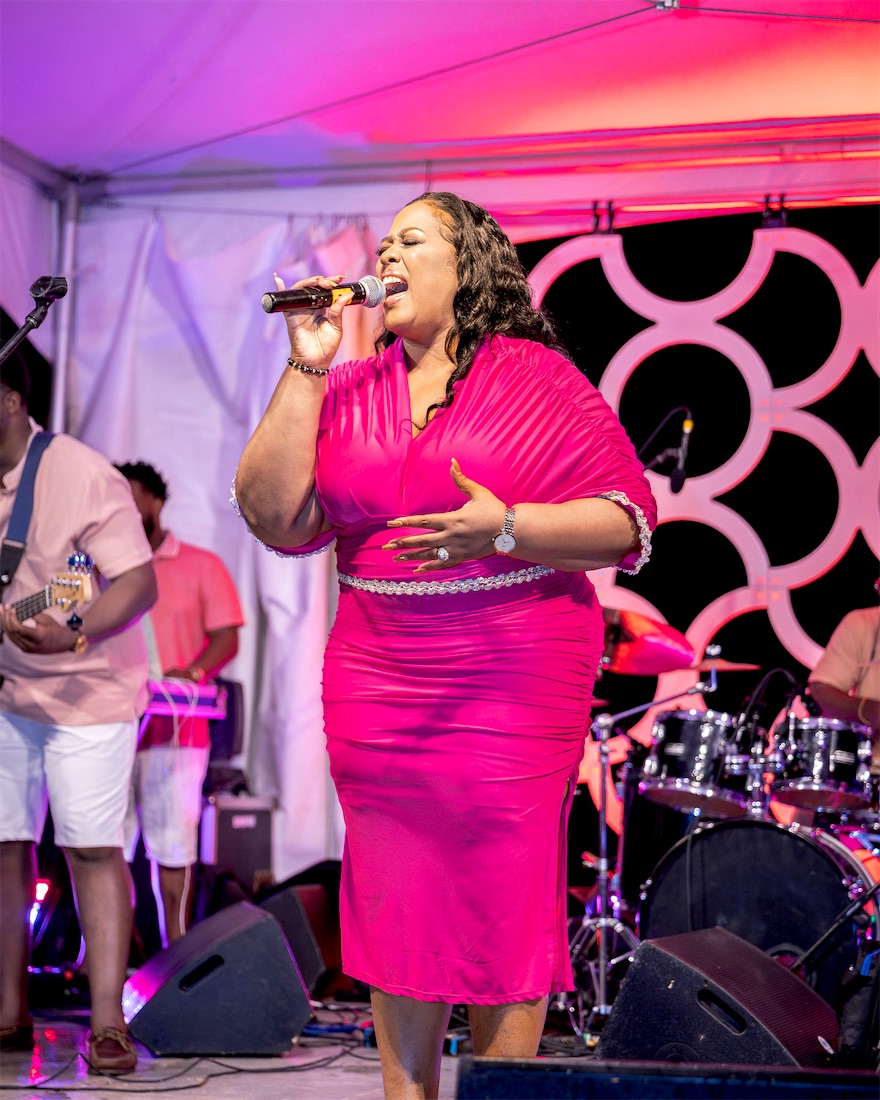 Queen B in pink with the band