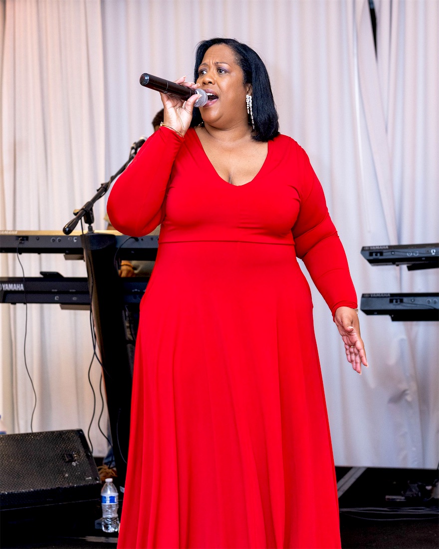 Queen B singing in a red gown