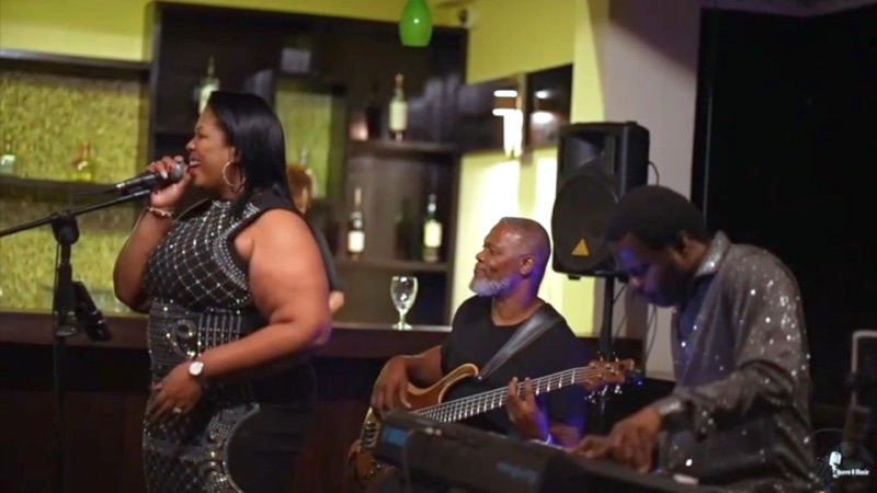 Queen B with bass and keys in a restaurant