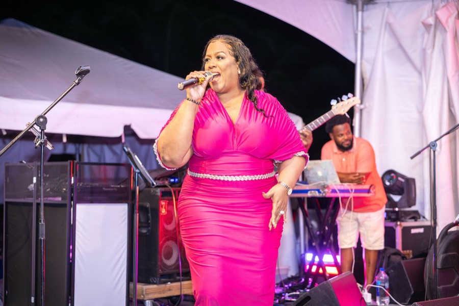 Queen B singing with her band at Malliouhana